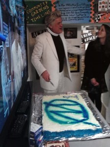 Reverend Billy of the Church of Stop Shopping cuts the cake to celebrate the 1 year anniversary of MORUS.